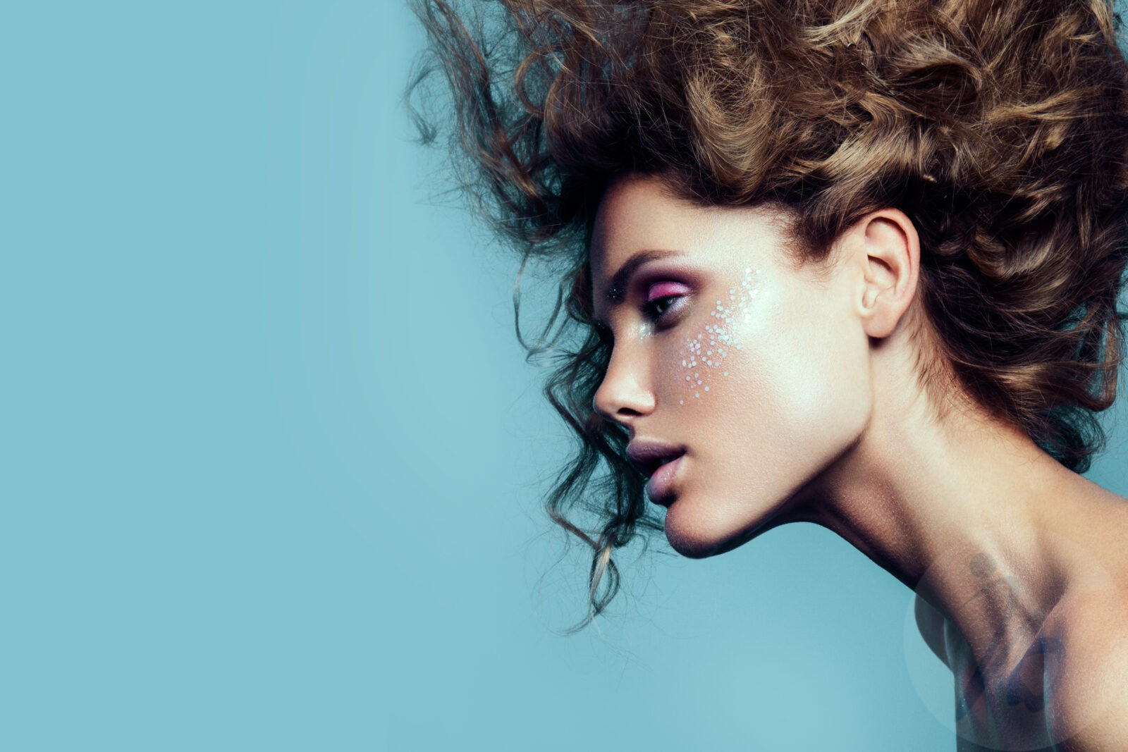 Close-up portrait of beautiful woman with bright make-up and hairstyle.