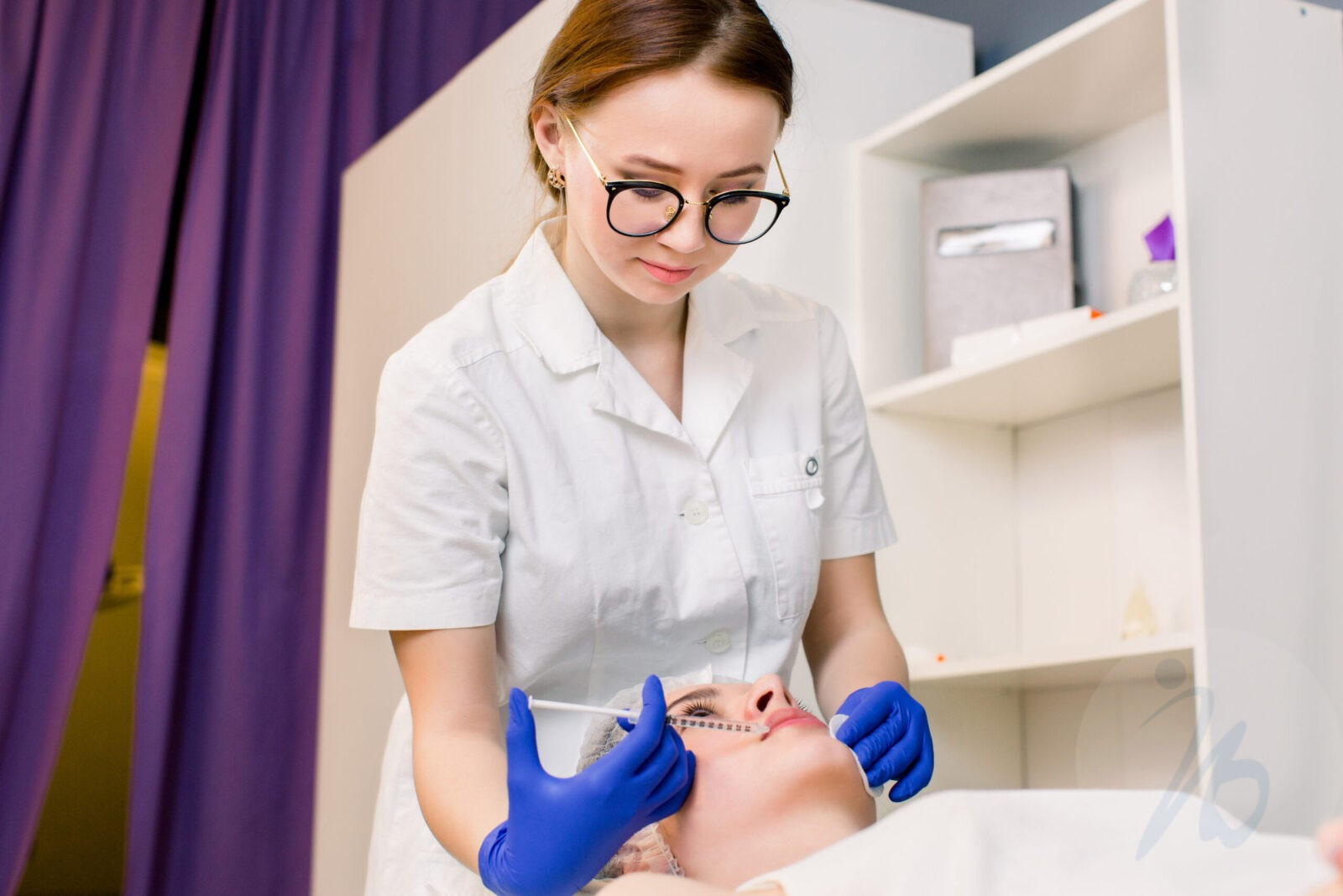 Plastic surgery. Young woman getting cosmetic injection in lips.